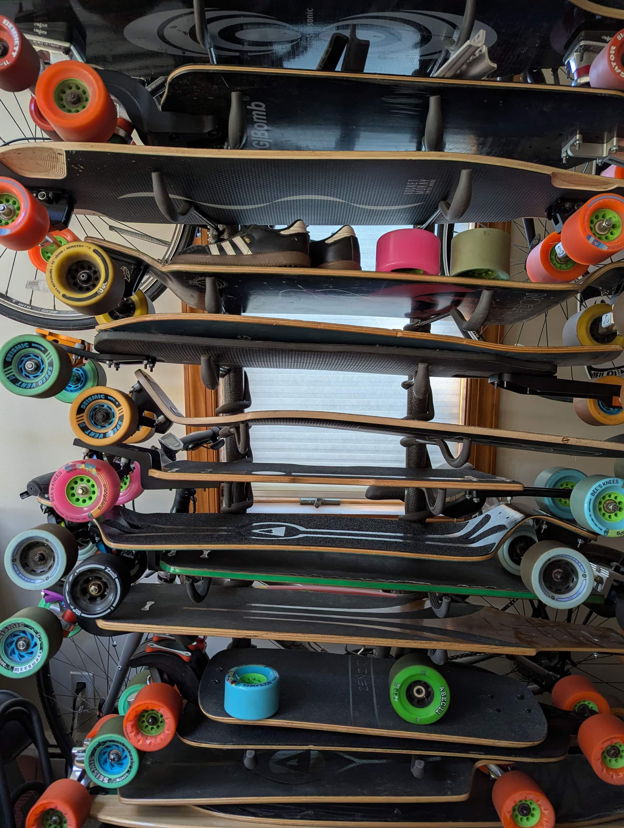Longboards and colorful wheels on a rack